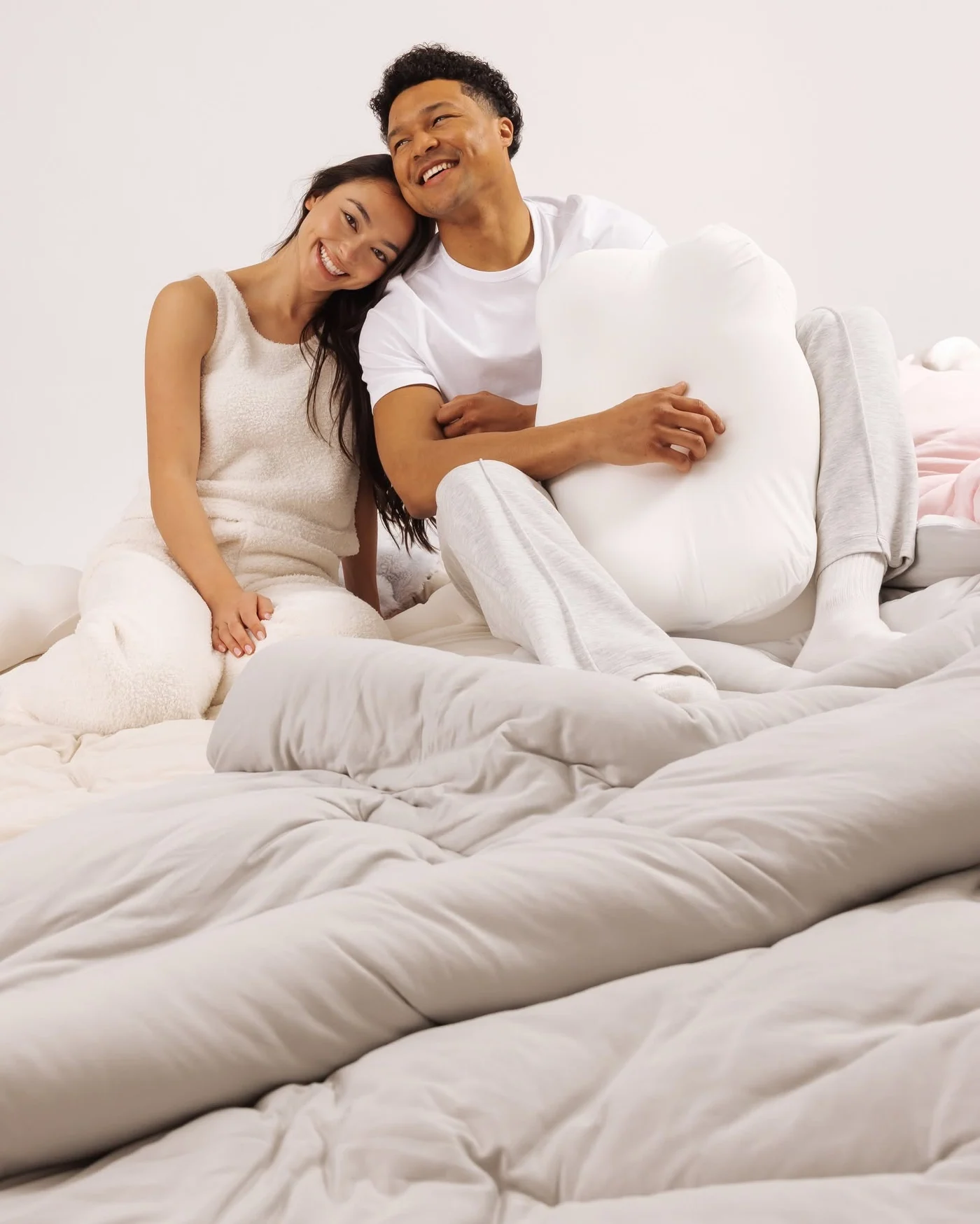 Couple sitting together with a white tag-free OrthoAlign pillow
